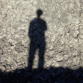 Physical body of man shadow on wall